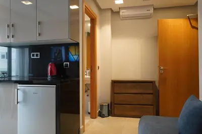 a kitchen with a counter top and a refrigerator at Agdotel Urban Suites in Rabat