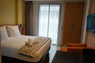 a hotel room with a bed with two teddy bears on it at Agdotel Urban Suites in Rabat