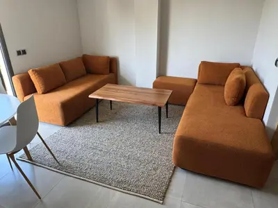 a living room with a couch and a table at Agdotel Urban Suites in Rabat