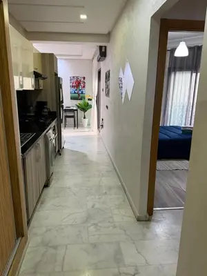 a hallway leading to a kitchen and a living room at Studio Stade Morocco for family in Mohammedia