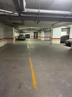 an empty parking garage with cars parked in it at Studio Stade Morocco for family in Mohammedia
