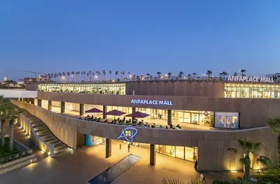 an arena mall at night with people walking around it at Luxurious & Central Princesses in Casablanca