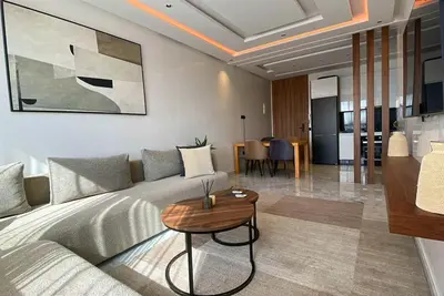 a living room with a bed and a table at Quiet haven near Sheikh Khalifa Hospital in Casablanca