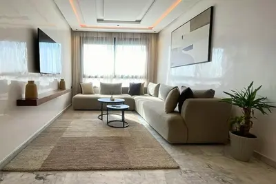a living room with a couch and a table at Quiet haven near Sheikh Khalifa Hospital in Casablanca