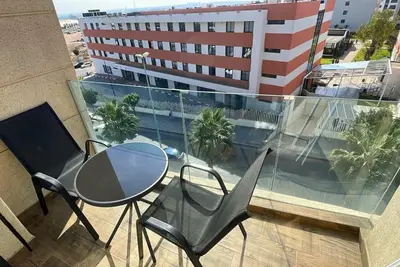 a balcony with a table and chairs and a building at Quiet haven near Sheikh Khalifa Hospital in Casablanca