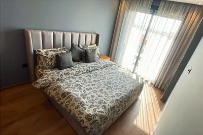 a bedroom with a large bed with pillows at Quiet haven near Sheikh Khalifa Hospital in Casablanca