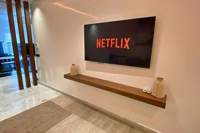 a television on a wall with a netflix sign on it at Quiet haven near Sheikh Khalifa Hospital in Casablanca