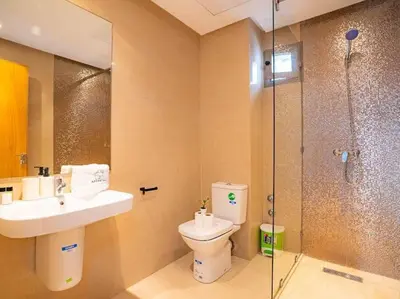 a bathroom with a toilet and a sink and a shower at Travel and Leisure - By AppartAli in Casablanca