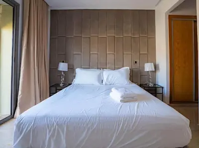 a bedroom with a large white bed with two lamps at Casa Contemporary 3 Beds - By AppartAli in Casablanca