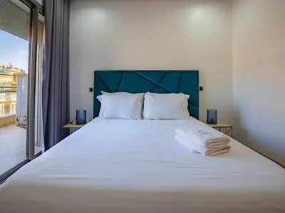 a bedroom with a large white bed with a blue headboard at Casa Contemporary 3 Beds - By AppartAli in Casablanca