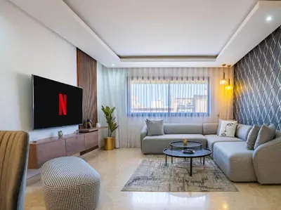 a living room with a couch and a tv at Casa Contemporary 3 Beds - By AppartAli in Casablanca