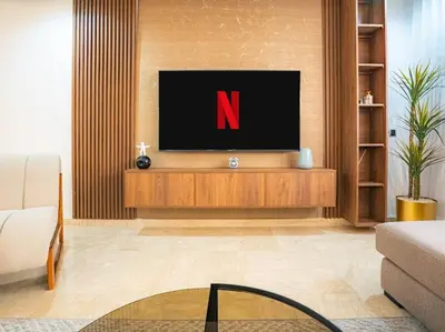 a living room with a tv on a wooden entertainment center at Casablanca Breeze - By AppartAli in Casablanca