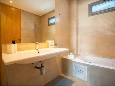 a bathroom with a sink and a bath tub at Casablanca Breeze - By AppartAli in Casablanca