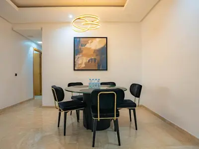 a dining room with a table and chairs at Casablanca Breeze - By AppartAli in Casablanca