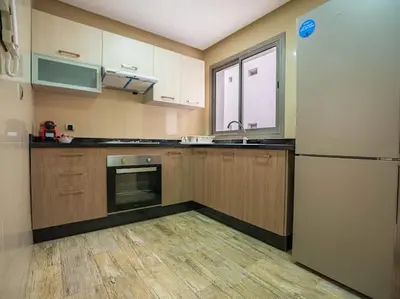 a kitchen with a refrigerator and a sink at Casablanca Breeze - By AppartAli in Casablanca