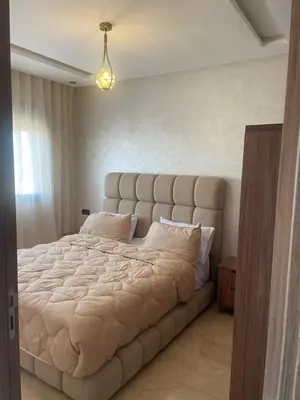 a large bed in a bedroom with a large headboard at Studio moderne avec parking ascenseur -Maarif Centre in Aïn Sebaa