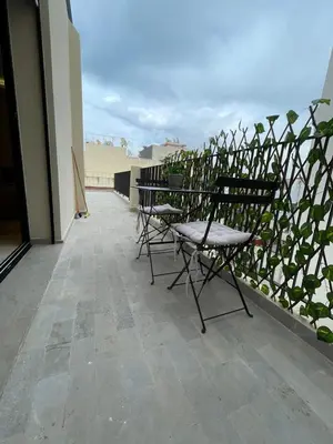 a group of chairs sitting on top of a balcony at Studio moderne avec parking ascenseur -Maarif Centre in Aïn Sebaa
