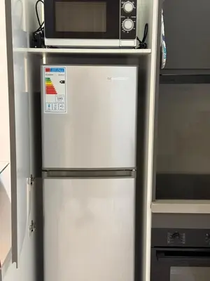 a refrigerator with a microwave on top of it at Luxe studio plein centre ville in Casablanca