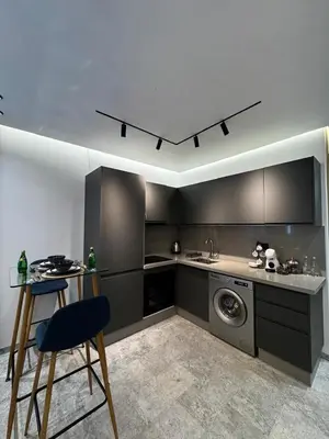 a kitchen with a table and a washing machine in it at Luxe studio plein centre ville in Casablanca
