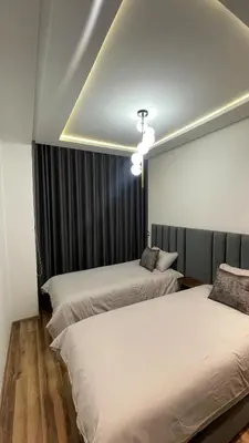 two beds in a room with black curtains at Cozy apartment 2 bedrooms 2 bathrooms in Casablanca