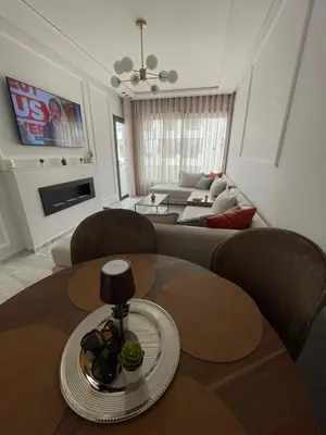 a living room with a couch and a table at Cozy apartment 2 bedrooms 2 bathrooms in Casablanca