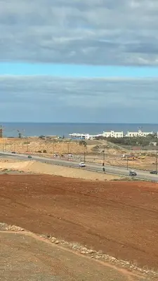 a road in the middle of a desert with cars at Cozy apartment 2 bedrooms 2 bathrooms in Casablanca