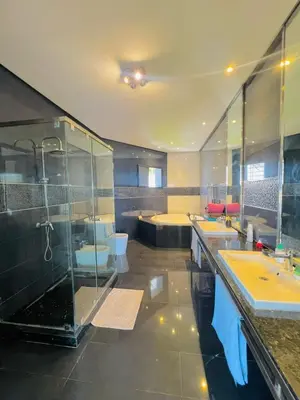 a large bathroom with two sinks and a shower at Waterfront Villa & Private Pool 12 km from the Stadium in Temara