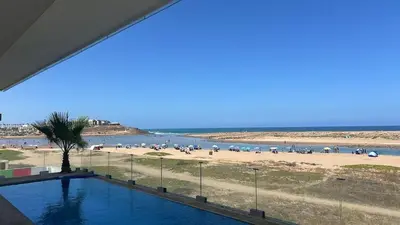 a view of a beach with a swimming pool and a beach at Waterfront Villa & Private Pool 12 km from the Stadium in Temara