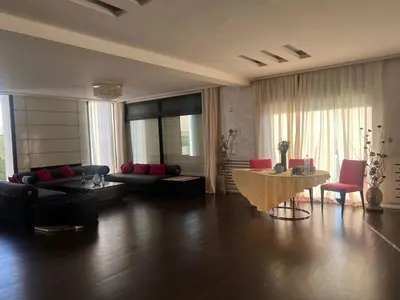 a living room with a couch and a table at Waterfront Villa & Private Pool 12 km from the Stadium in Temara