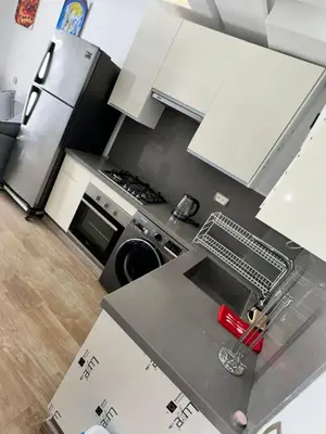 an aerial view of a kitchen with white cabinets at Stay luxe in Casablanca