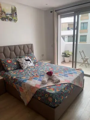 a bedroom with a bed with a stuffed animal on it at Stay luxe in Casablanca