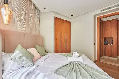 a bedroom with a bed with a cross on it at AFCON Casablanca 5 min Walk to Stadium Private Terrace 65 inch TV Fiber Internet All Sports Channels in Casablanca