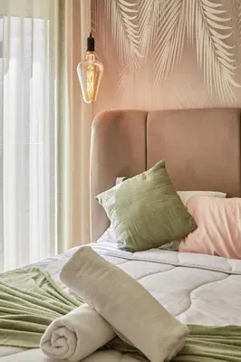 a bedroom with a bed with a pillow and a window at AFCON Casablanca 5 min Walk to Stadium Private Terrace 65 inch TV Fiber Internet All Sports Channels in Casablanca