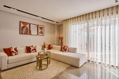 a living room with a couch and a table at AFCON Casablanca 5 min Walk to Stadium Private Terrace 65 inch TV Fiber Internet All Sports Channels in Casablanca