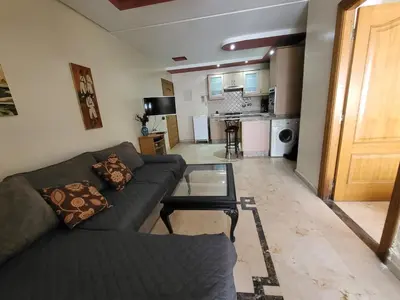 a living room with a couch and a glass table at wbdixmude in Casablanca