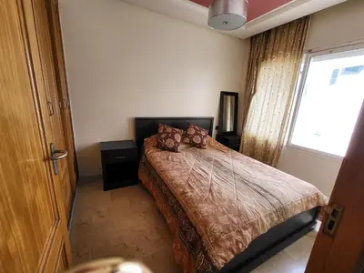 a bedroom with a bed and a large window at wbdixmude in Casablanca