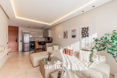 a living room with a couch and a table at Aura - 1 BR - Premium Apartment in Maarif