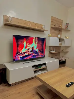 a living room with a large flat screen tv at Cozy appartement Rabat Wifak 5min de Harhoura beach in Temara