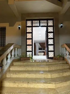 an entrance to a building with stairs and a door at Harhoura stay à 10min du stade Prince Moulay Abdellah ! in Temara