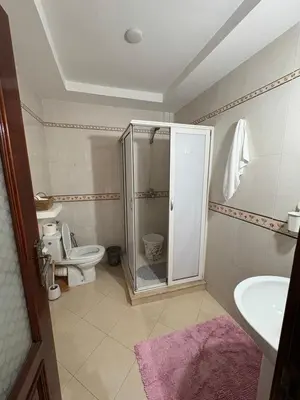 a bathroom with a shower and a toilet and a sink at Harhoura stay à 10min du stade Prince Moulay Abdellah ! in Temara