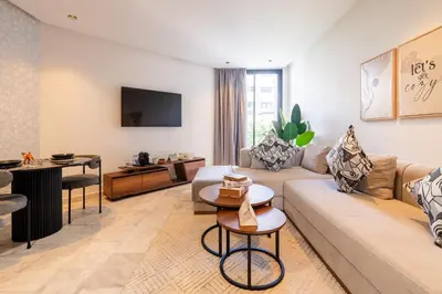 a living room with a couch and a table at 1BR Private Terrace Parking Gym in Casablanca