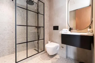 a bathroom with a shower and a toilet and a sink at 1BR Private Terrace Parking Gym in Casablanca