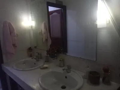 a bathroom with a sink and a mirror at 2 bedroom apartment and living room with small terrace in Skhirat