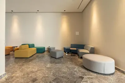 a waiting room with couches and chairs in a room at Self Check In 1BR With Gym And Coworking Near CFC in Casablanca