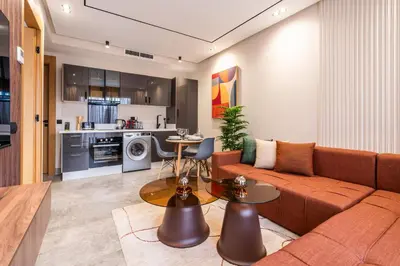 a living room with a couch and a table at Self Check In 1BR With Gym And Coworking Near CFC in Casablanca