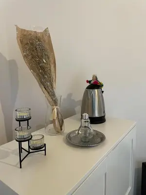 a table with a tea kettle and candles on it at Cozy getaway for a perfect stay in Rabat