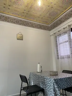 a dining room with a table with chairs and a ceiling at Cozy getaway for a perfect stay in Rabat