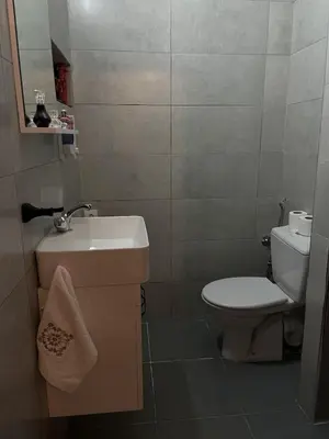 a small bathroom with a sink and a toilet at Cozy getaway for a perfect stay in Rabat