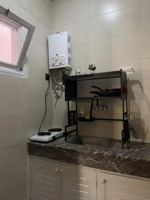 a kitchen counter with a sink and a microwave at Cozy getaway for a perfect stay in Rabat