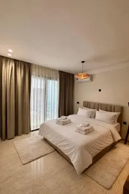 a bedroom with a large bed with two towels on it at Cosy Loft with Sauna - City Center Casablanca in Casablanca